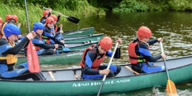Canoeing youths lake
